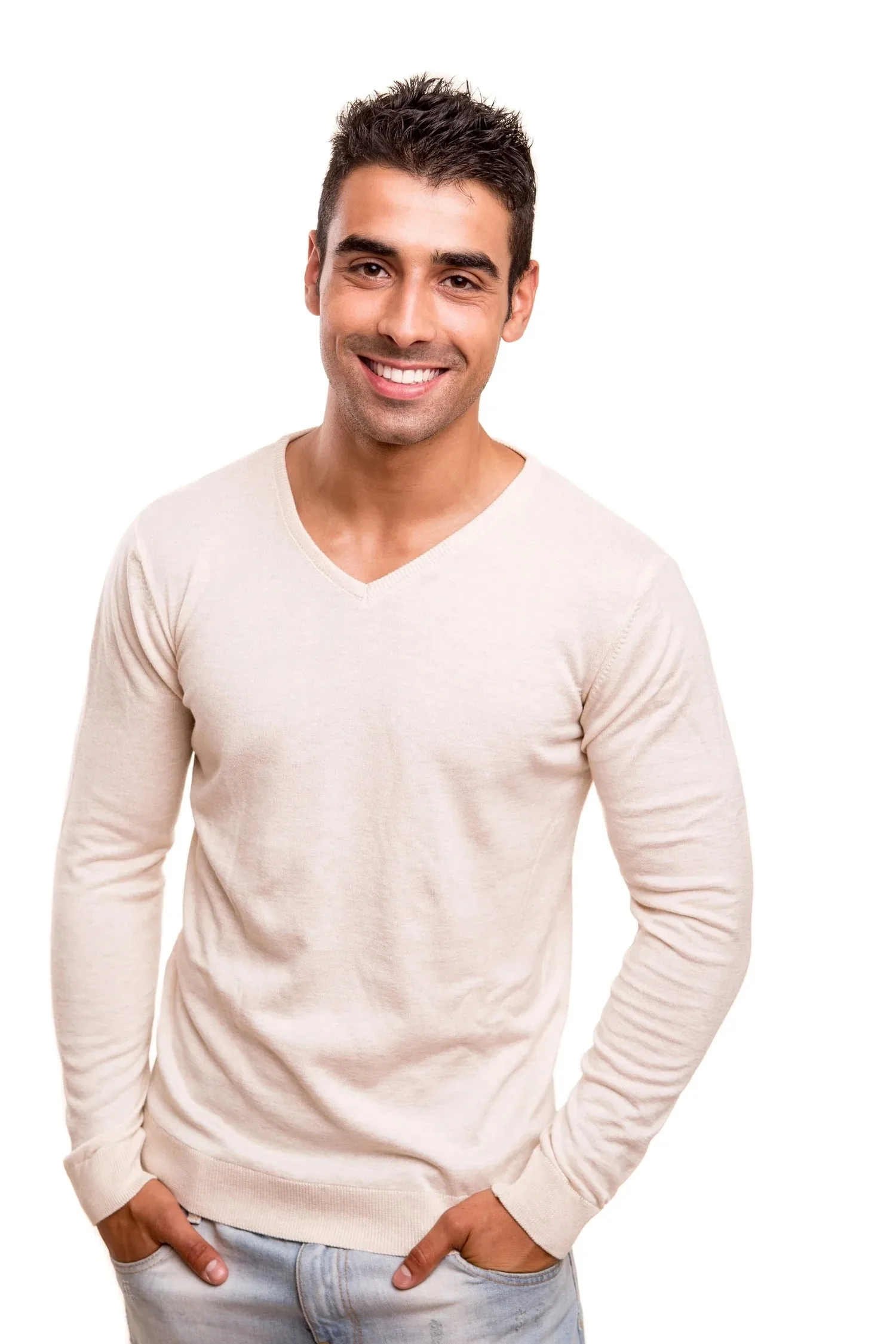 A smiling adult with visible teeth wearing a light v-neck sweater against a plain white background.